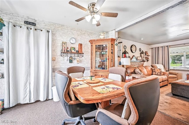 4477 S Warwick Dr, Canfield, OH 44406 - dining area featuring carpet, a ceiling fan, and brick wall