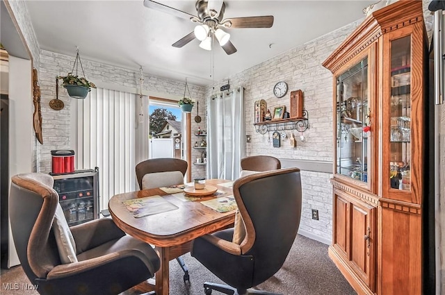 4477 S Warwick Dr, Canfield, OH 44406 - carpeted dining space with brick wall, a ceiling fan, and wine cooler