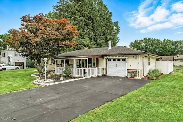 4477 S Warwick Dr, Canfield, OH 44406 - single story home featuring an attached garage, a porch, asphalt driveway, a front yard, and stone siding