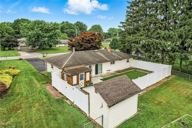 4477 S Warwick Dr, Canfield, OH 44406 - back of property featuring a shingled roof and a fenced backyard
