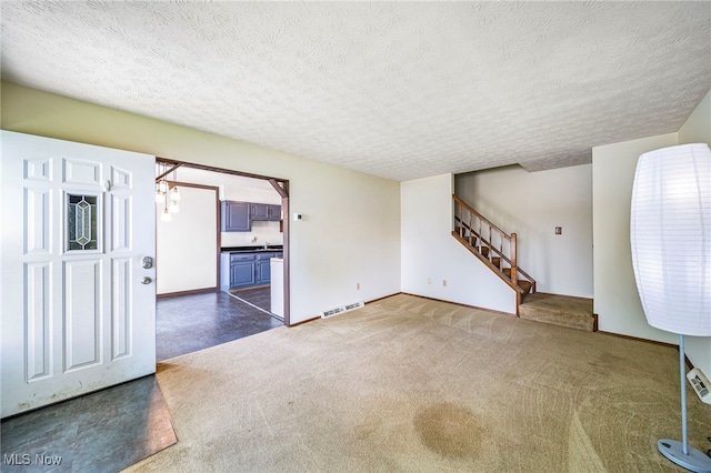 5523 Weston Ct Unit 88A, Willoughby, OH 44094 - unfurnished living room with carpet flooring, a textured ceiling, and stairway