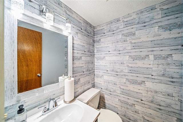 5523 Weston Ct Unit 88A, Willoughby, OH 44094 - half bath with wood walls, a textured ceiling, and vanity