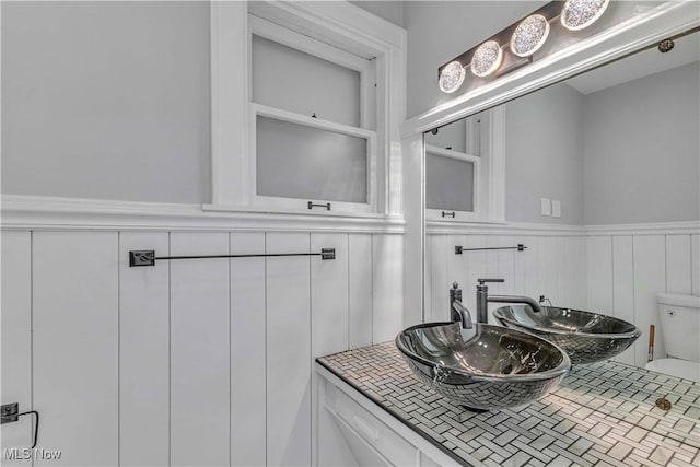 13050 Diagonal Rd, Salem, OH 44460 - bathroom featuring wainscoting, vanity, and a decorative wall