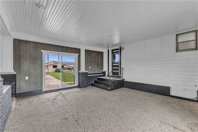 13050 Diagonal Rd, Salem, OH 44460 - unfurnished living room featuring wooden walls and speckle patterned floor