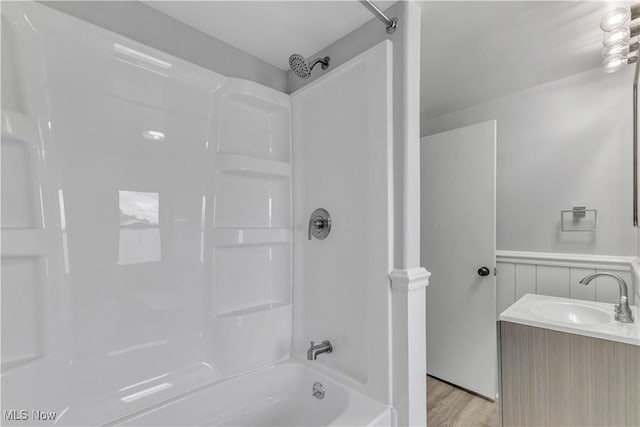 13050 Diagonal Rd, Salem, OH 44460 - full bath with washtub / shower combination, vanity, a wainscoted wall, and wood finished floors