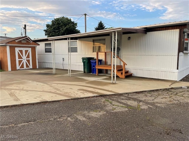 9329 Infirmary Unit C13, Mantua, OH 44255 - view of front of house with a shed and a patio