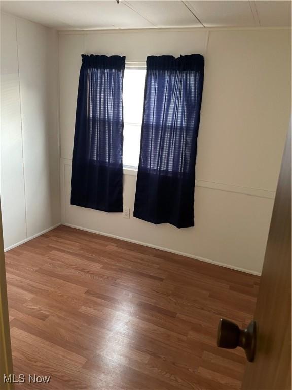9329 Infirmary Unit C13, Mantua, OH 44255 - unfurnished room featuring wood finished floors and baseboards