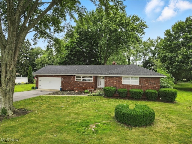 4833 Middle Ridge Rd, Perry, OH 44081 - ranch-style home featuring a garage, concrete driveway, brick siding, and a front yard