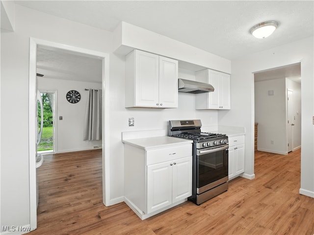 4833 Middle Ridge Rd, Perry, OH 44081 - kitchen with stainless steel range with gas cooktop, wall chimney range hood, light wood-type flooring, and light countertops