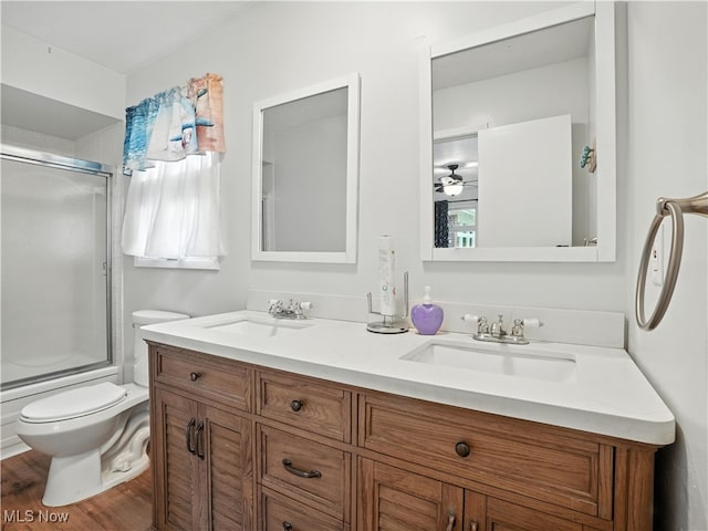 4833 Middle Ridge Rd, Perry, OH 44081 - full bath featuring double vanity, wood finished floors, and shower / bath combination with glass door