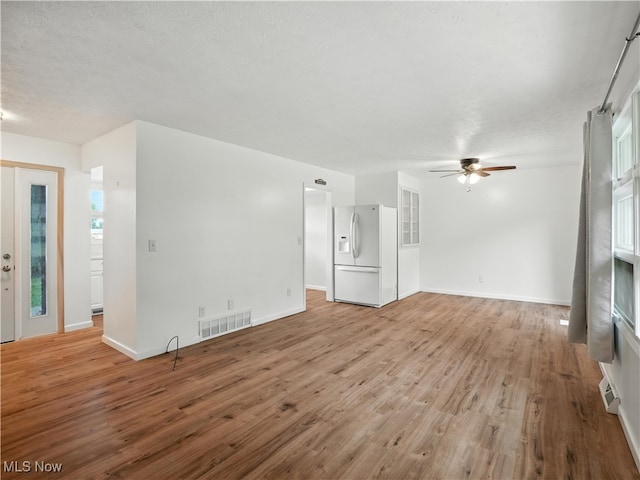 4833 Middle Ridge Rd, Perry, OH 44081 - unfurnished living room featuring a ceiling fan, light wood-style flooring, and a textured ceiling