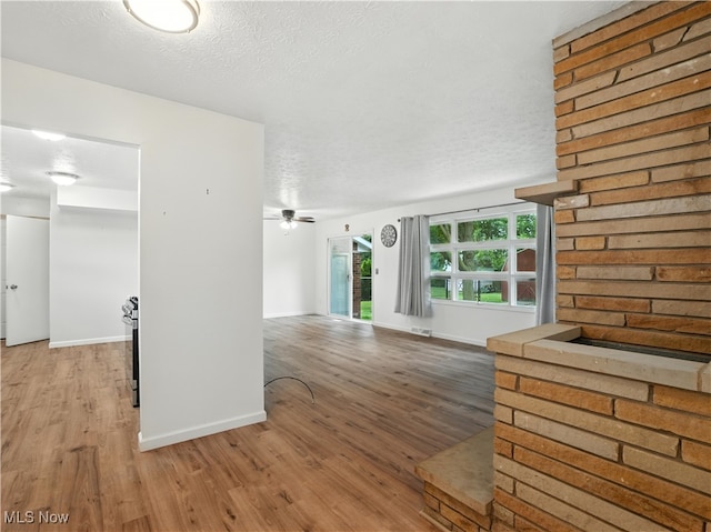 4833 Middle Ridge Rd, Perry, OH 44081 - unfurnished living room with light wood-style floors, a textured ceiling, and a ceiling fan