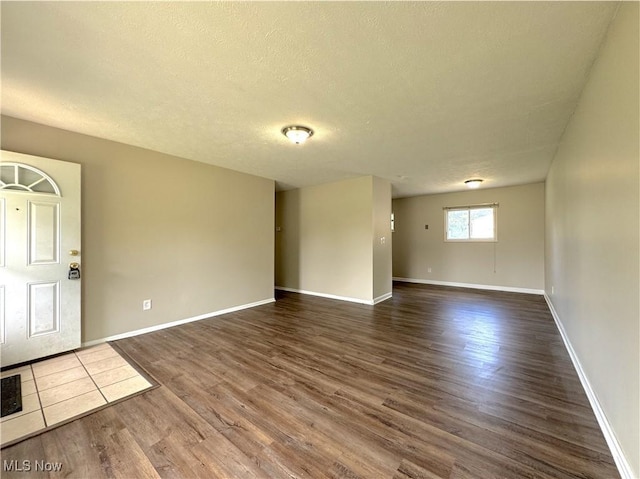 24525 Sherborne Rd, Bedford Heights, OH 44146 - unfurnished room featuring dark wood finished floors and a textured ceiling