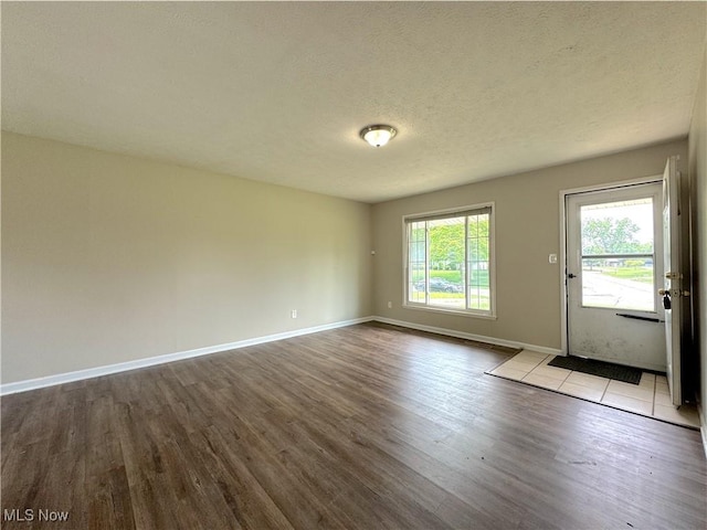 24525 Sherborne Rd, Bedford Heights, OH 44146 - empty room with wood finished floors and a textured ceiling