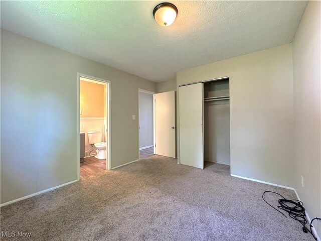 24525 Sherborne Rd, Bedford Heights, OH 44146 - unfurnished bedroom featuring carpet, a closet, and a textured ceiling