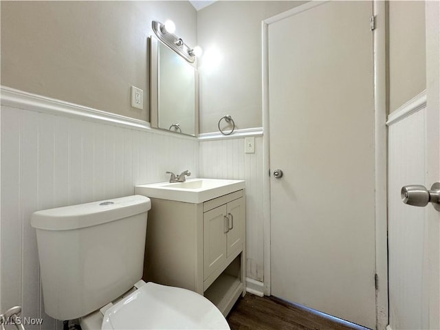 24525 Sherborne Rd, Bedford Heights, OH 44146 - bathroom featuring wainscoting, vanity, and wood finished floors