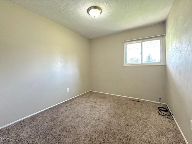 24525 Sherborne Rd, Bedford Heights, OH 44146 - carpeted spare room with a textured ceiling and baseboards
