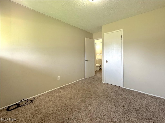 24525 Sherborne Rd, Bedford Heights, OH 44146 - carpeted spare room featuring baseboards and a textured ceiling