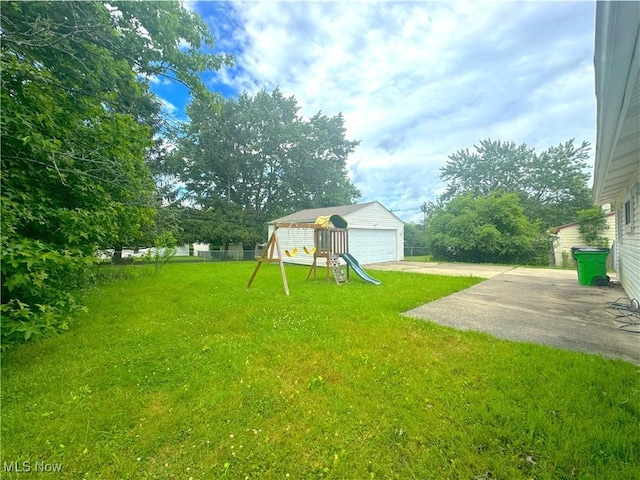 24525 Sherborne Rd, Bedford Heights, OH 44146 - view of grassy yard featuring a playground, a garage, and a patio
