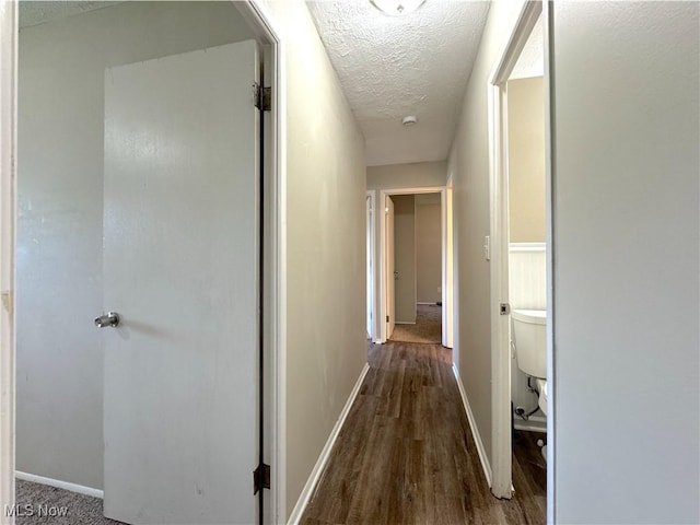 24525 Sherborne Rd, Bedford Heights, OH 44146 - corridor with a textured ceiling and wood finished floors