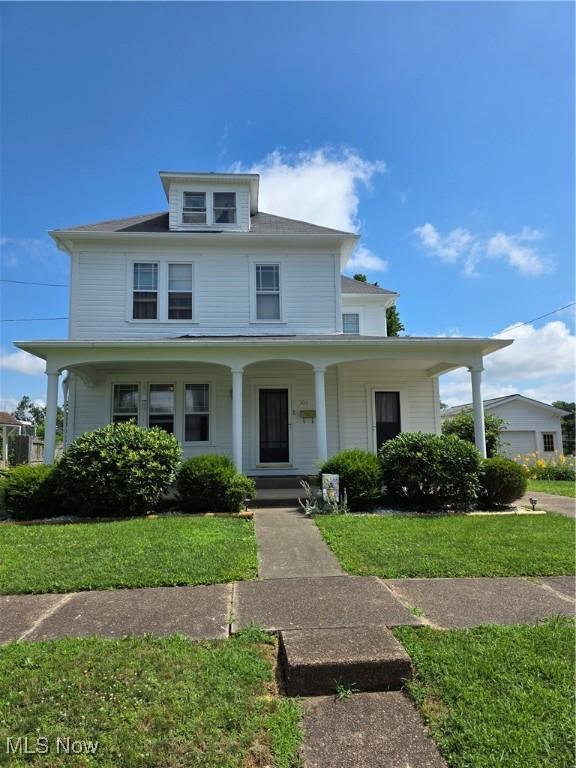 302 High St, Woodsfield, OH 43793 - view of front of home with covered porch and a front yard
