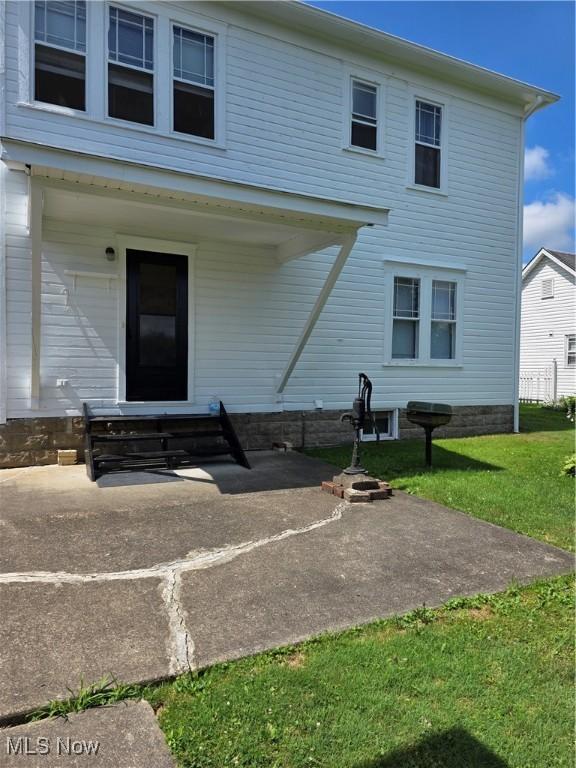 302 High St, Woodsfield, OH 43793 - rear view of property with a lawn and a patio area