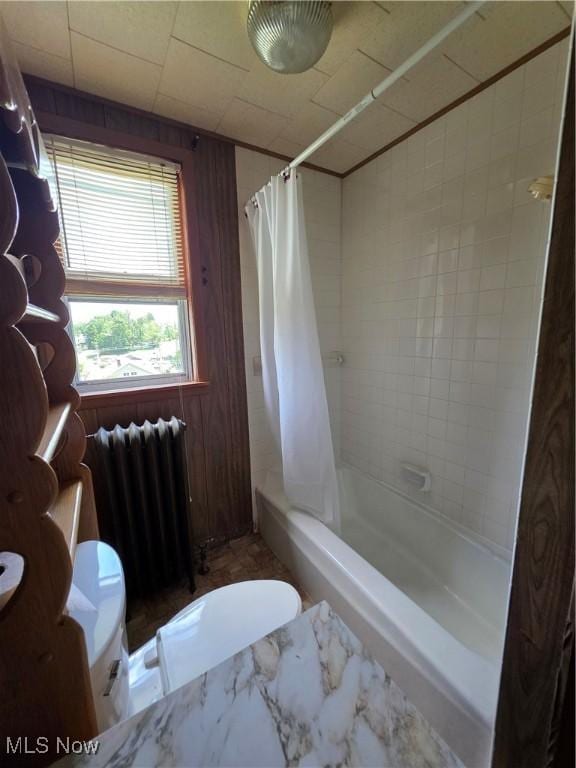 302 High St, Woodsfield, OH 43793 - full bath with radiator, shower / tub combo, and wood walls