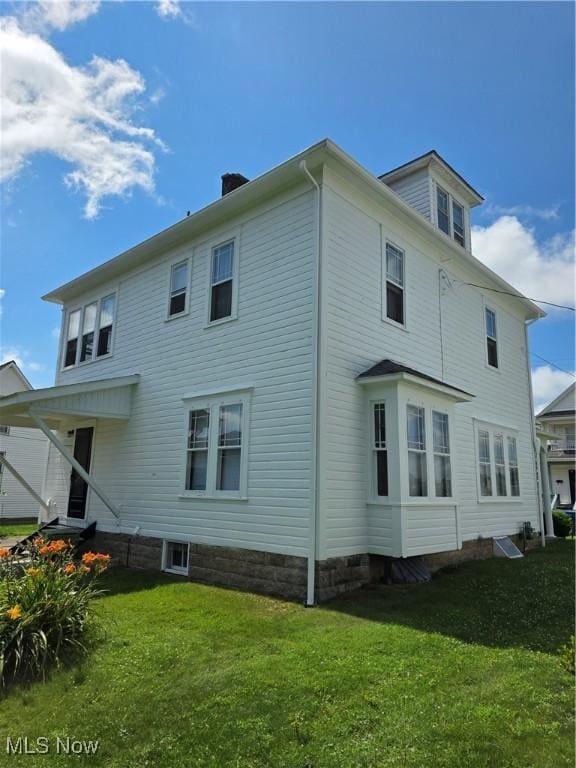 302 High St, Woodsfield, OH 43793 - rear view of house featuring a lawn and a chimney