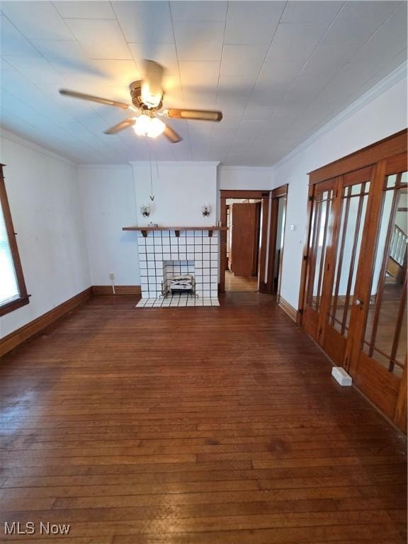 302 High St, Woodsfield, OH 43793 - unfurnished living room with dark wood-style flooring, ornamental molding, a ceiling fan, and a tile fireplace
