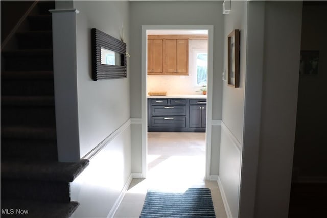 812 Spring Water Dr, Akron, OH 44333 - hall featuring stairs, wainscoting, and a decorative wall