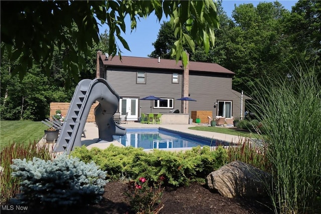 812 Spring Water Dr, Akron, OH 44333 - rear view of house with a patio, an outdoor pool, french doors, and a chimney