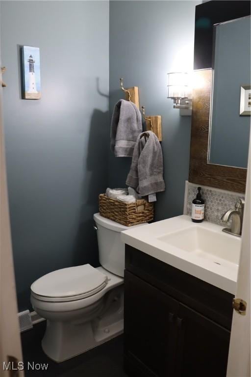 812 Spring Water Dr, Akron, OH 44333 - half bathroom featuring vanity and tasteful backsplash