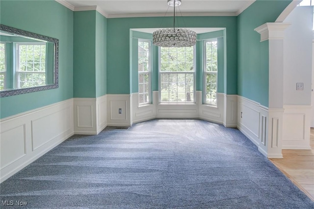 1741 Hamilton Dr, Broadview Heights, OH 44147 - spare room featuring plenty of natural light, a chandelier, a wainscoted wall, crown molding, and carpet flooring
