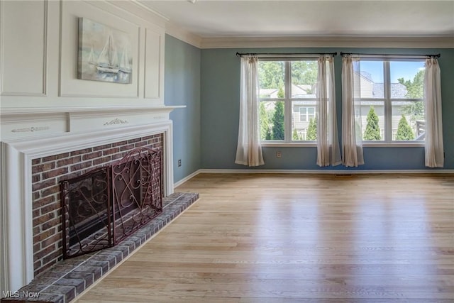 1741 Hamilton Dr, Broadview Heights, OH 44147 - unfurnished living room with light wood finished floors, a fireplace with raised hearth, and crown molding
