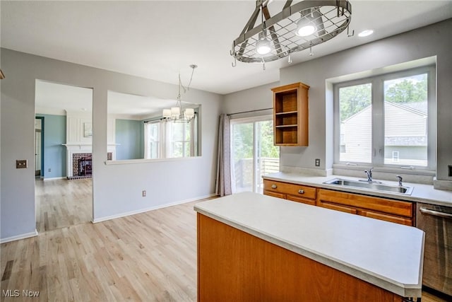 1741 Hamilton Dr, Broadview Heights, OH 44147 - kitchen with dishwasher, brown cabinets, a chandelier, light wood finished floors, and light countertops