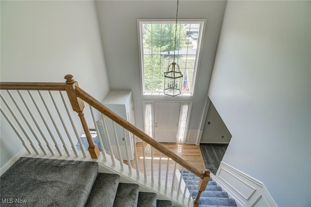 1741 Hamilton Dr, Broadview Heights, OH 44147 - stairway with a chandelier, a high ceiling, and wood finished floors