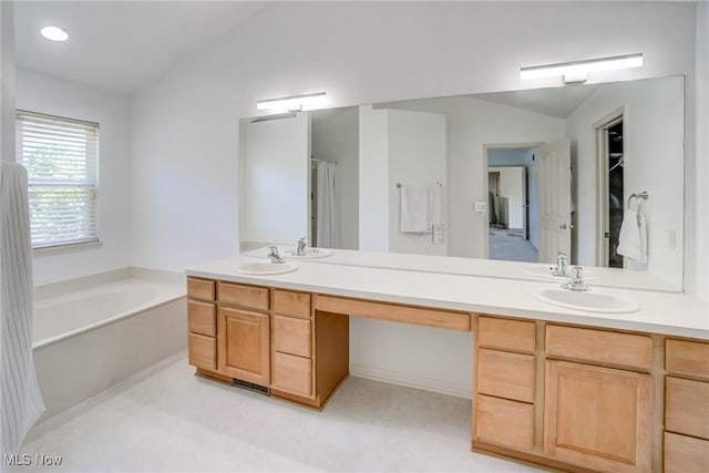 1741 Hamilton Dr, Broadview Heights, OH 44147 - bathroom with double vanity, a bath, and vaulted ceiling