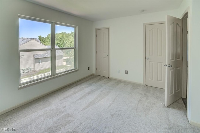 1741 Hamilton Dr, Broadview Heights, OH 44147 - unfurnished bedroom with light colored carpet and multiple closets