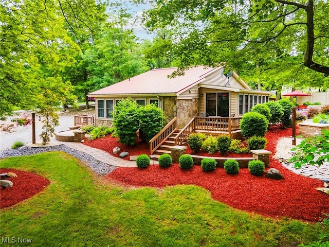 7235 Spillway Rd, Lisbon, OH 44408 - ranch-style house with stone siding, a wooden deck, stairs, and a front yard