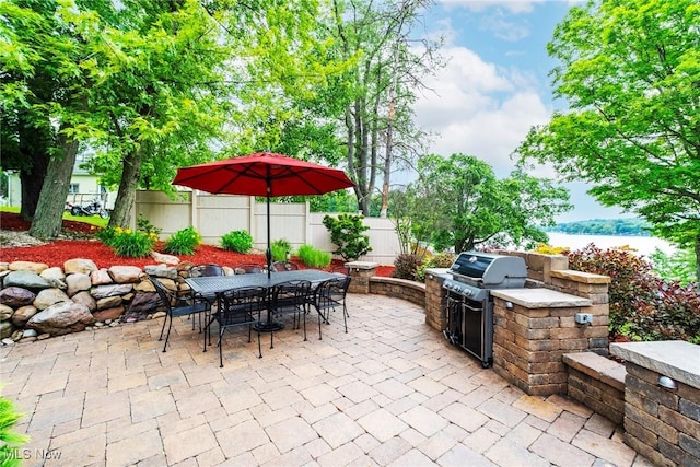 7235 Spillway Rd, Lisbon, OH 44408 - view of patio / terrace with outdoor dining area, area for grilling, and a water view