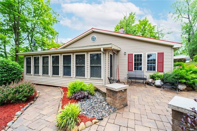 7235 Spillway Rd, Lisbon, OH 44408 - back of property with a patio and a chimney