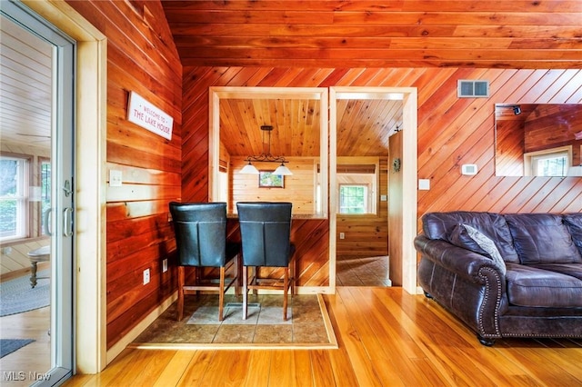 7235 Spillway Rd, Lisbon, OH 44408 - dining space featuring wood walls, wood finished floors, and healthy amount of natural light