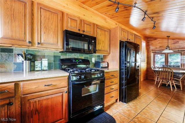 7235 Spillway Rd, Lisbon, OH 44408 - kitchen with black appliances, track lighting, light tile patterned flooring, brown cabinets, and light countertops