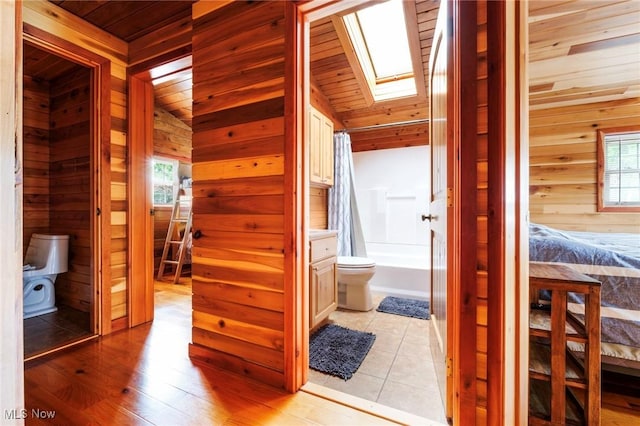 7235 Spillway Rd, Lisbon, OH 44408 - hall with wood ceiling, wood walls, a skylight, light wood-style floors, and vaulted ceiling