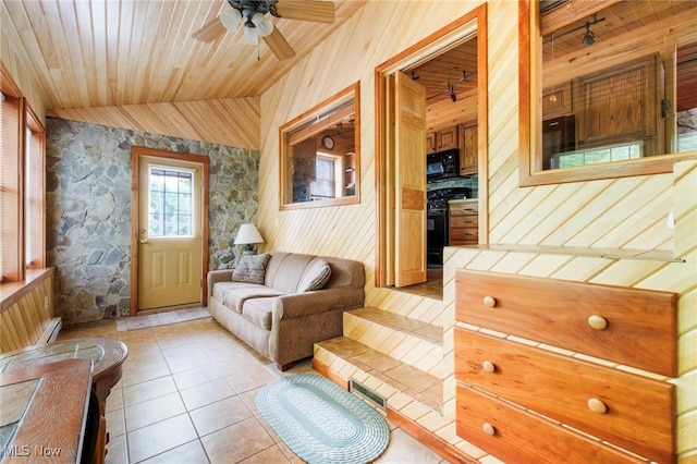 7235 Spillway Rd, Lisbon, OH 44408 - living area featuring wooden walls, ceiling fan, light tile patterned floors, wood ceiling, and vaulted ceiling