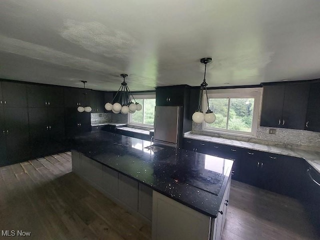 4985 State Route 213, Toronto, OH 43964 - kitchen featuring wood finished floors, a large island, tasteful backsplash, and dark cabinetry