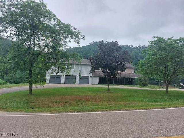 4985 State Route 213, Toronto, OH 43964 - obstructed view of property featuring driveway, a front lawn, and a garage