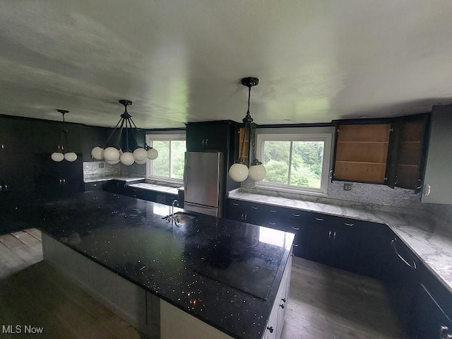4985 State Route 213, Toronto, OH 43964 - kitchen featuring freestanding refrigerator, healthy amount of natural light, a large island with sink, and stone counters