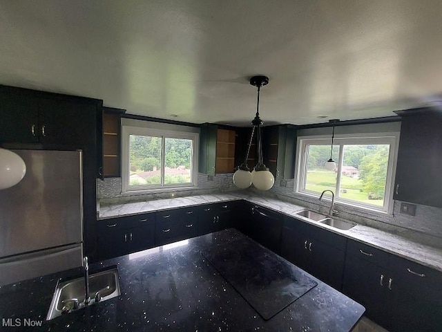 4985 State Route 213, Toronto, OH 43964 - kitchen featuring tasteful backsplash, dark cabinets, and light stone counters