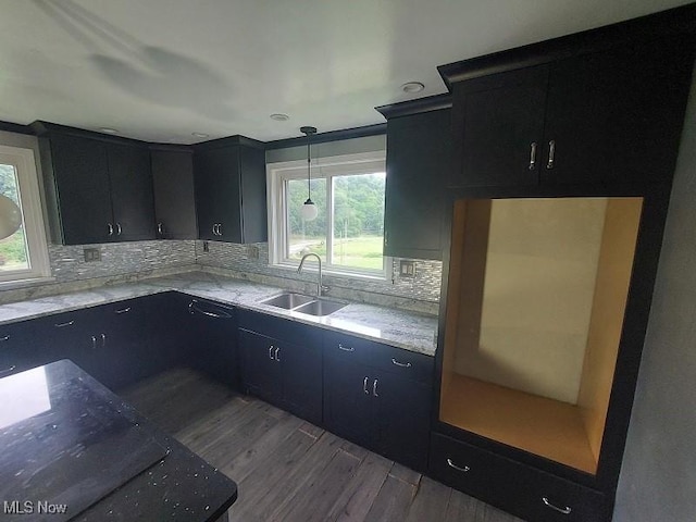 4985 State Route 213, Toronto, OH 43964 - kitchen featuring dark cabinets, dark wood-type flooring, backsplash, light stone countertops, and hanging light fixtures